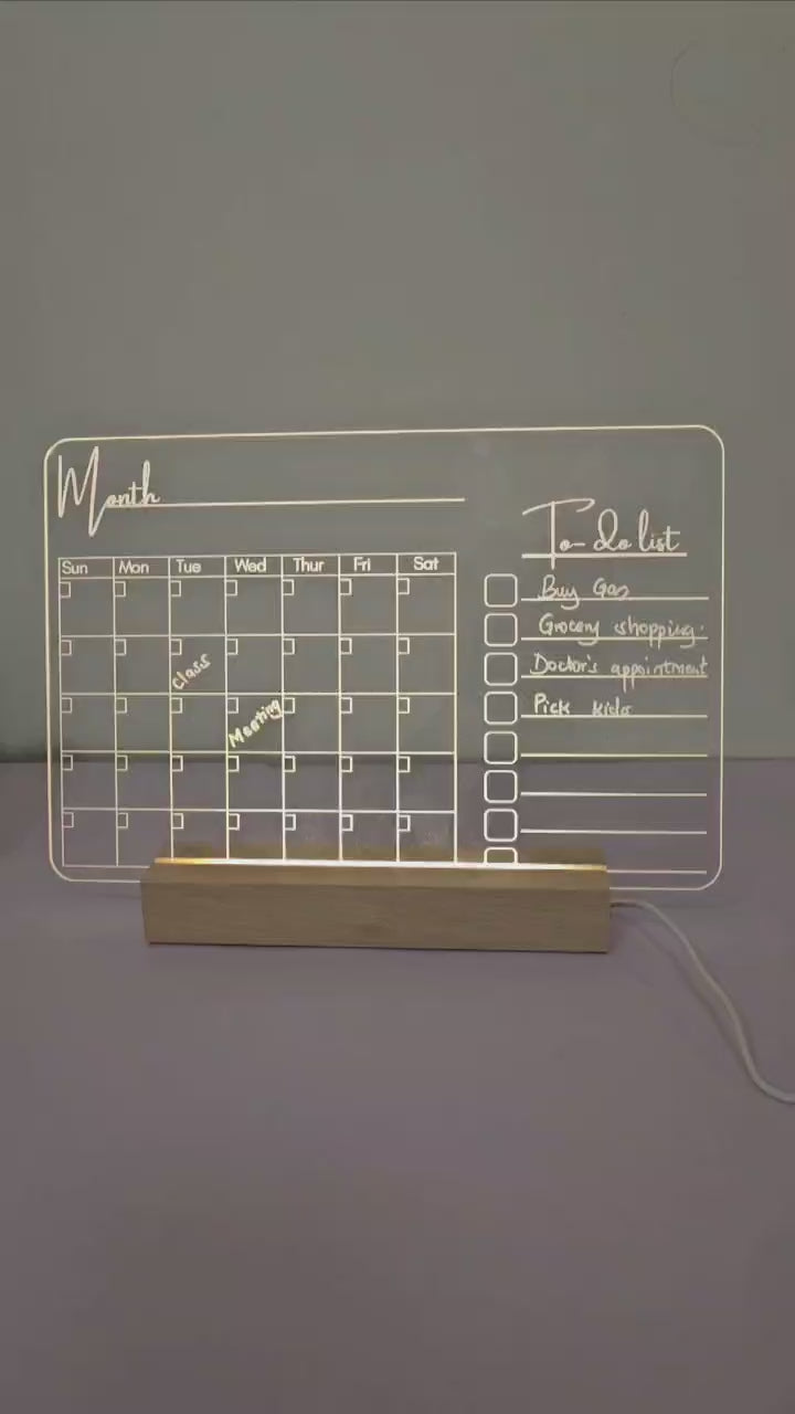 Acrylic desk planner with wooden holder.